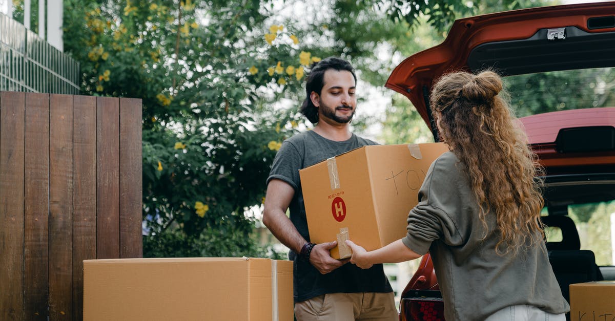 Why doesn't Sam use his ability to move things to open the door? - Boyfriend and girlfriend in casual wear helping each other with unpacking car while moving in together on sunny summer day