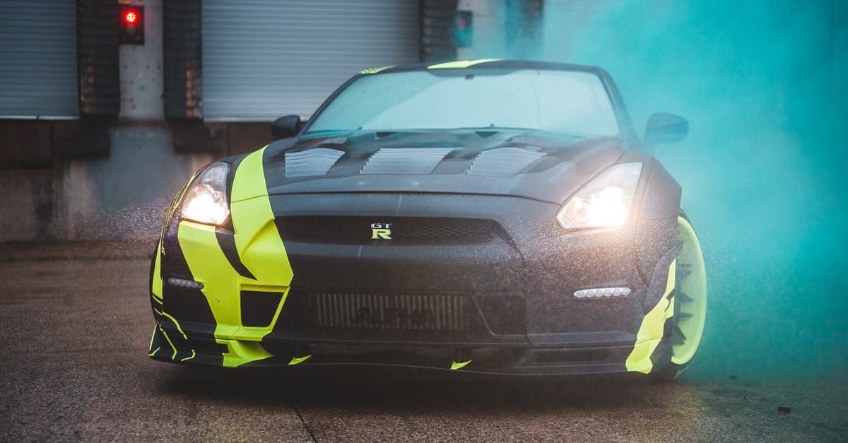 Why doesn't the bomb cause radiation poisoning to Gotham City? - Contemporary sports car with headlights lights and yellow wrapping design parked near wall with closed blinds in green fume from smoke bomb