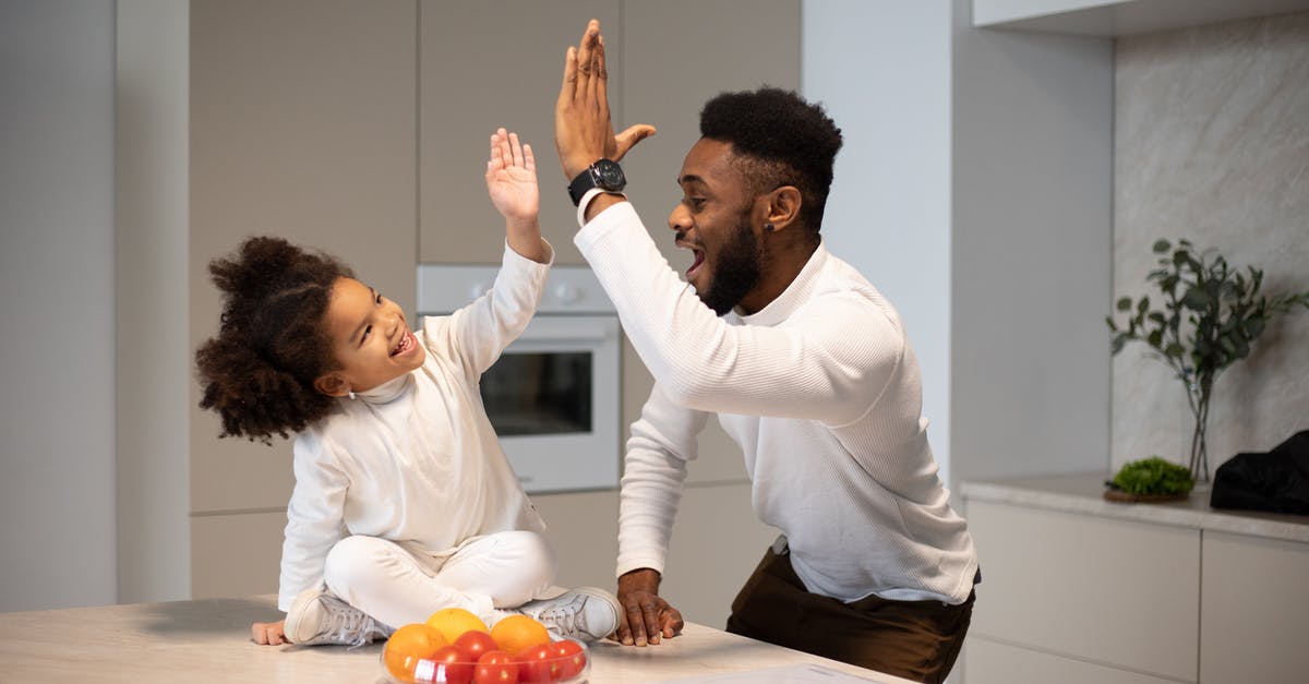 Why doesn't Vesper give Bond the additional $5M? - Joyful black father giving high five to adorable daughter
