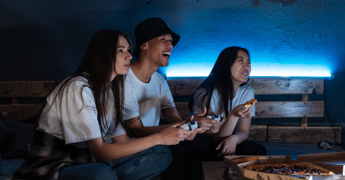 Why don't humans become Walkers when eating other humans who are infected? - People Playing Video Games while Eating Pizza
