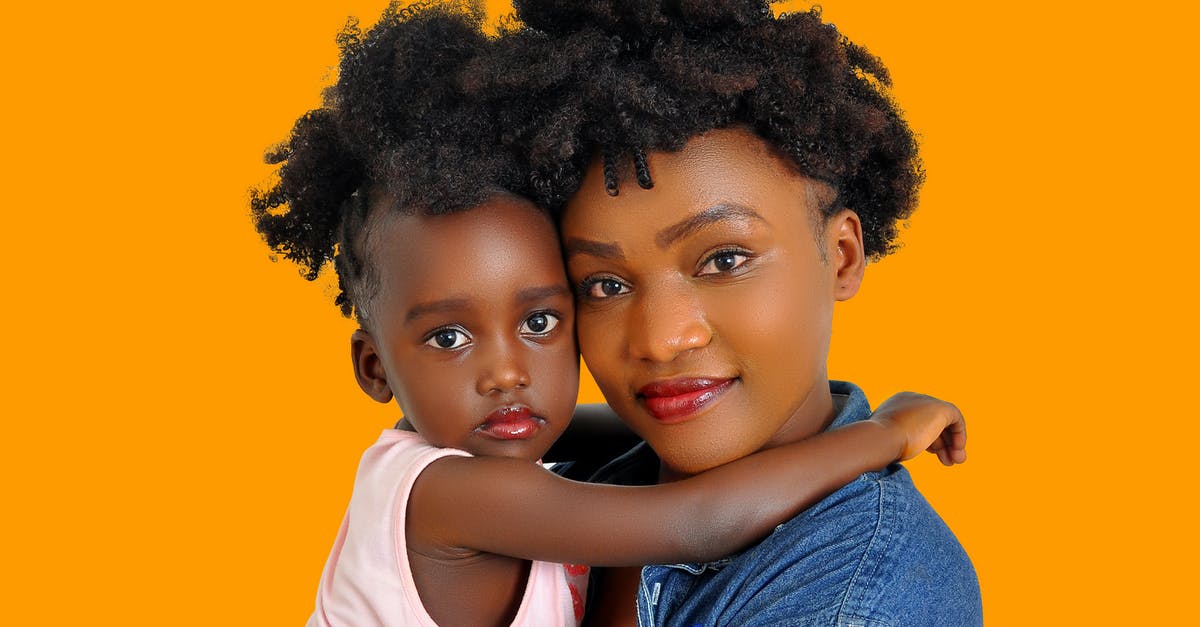 Why don't Marty's parents ever mention how similar he looks to the Marty of 1955? - Young African American female holding little girl on hands looking tenderly at camera on orange background