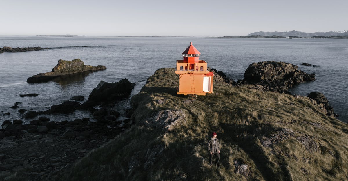 Why is Gwen Stacy (Emma Stone) in the Amazing Spider-man? - From above of lonely lighthouse keeper in warm clothes observing vicinities near small lighthouse on wild rocky seacoast