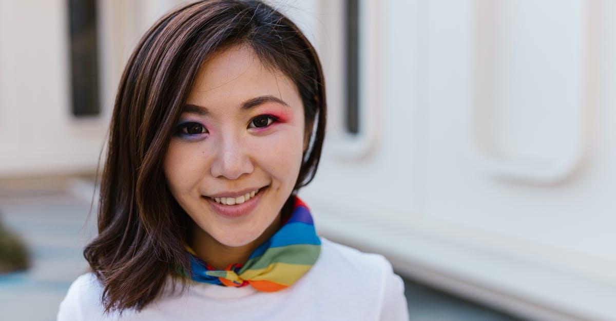 Why is Hannah wearing a scarf? - Portrait of Woman in Makeup Wearing Rainbow Scarf Around Neck