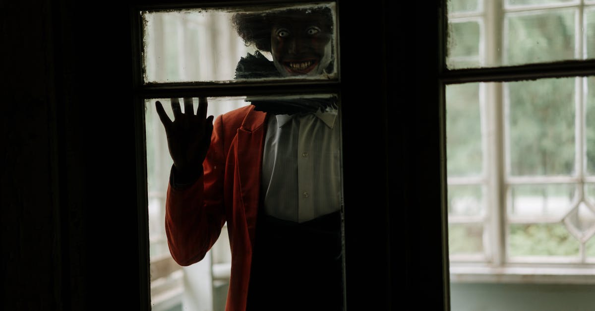 Why is it 'Elm' in 'A Nightmare on Elm Street'? - Man in White Dress Shirt and Red Vest Standing by the Window