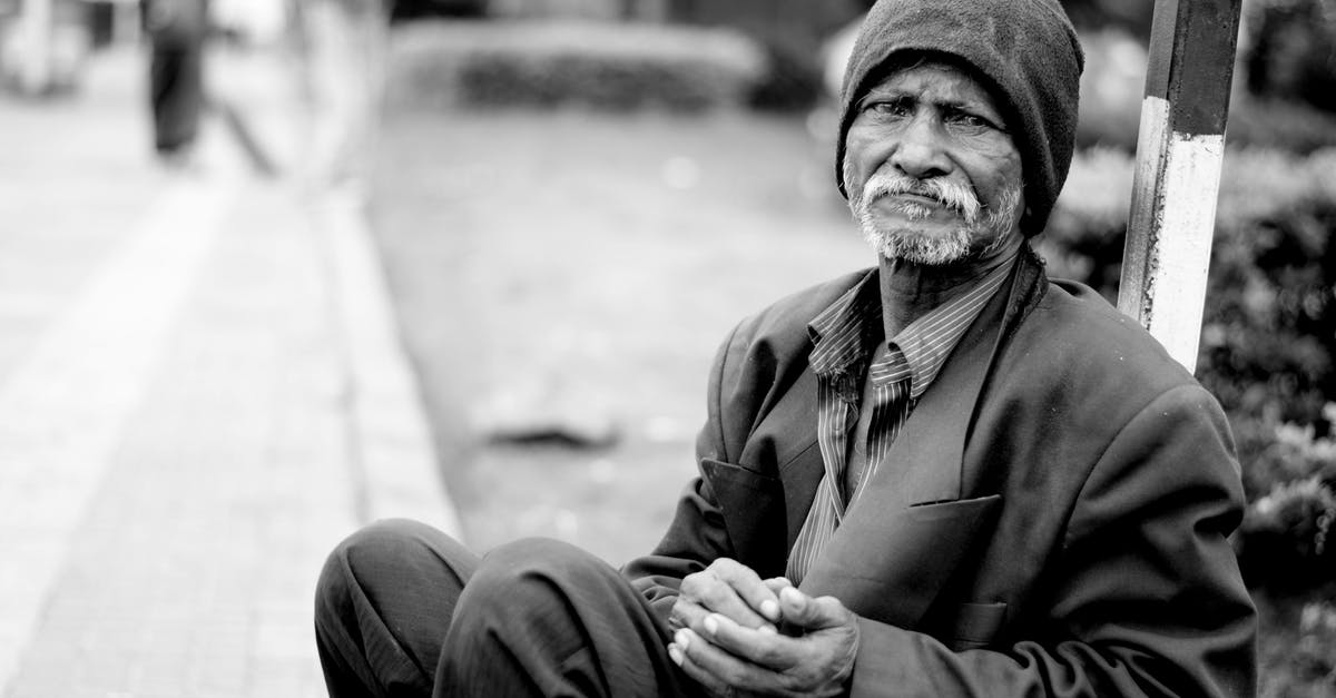 Why is Kathy Nicolo sometimes homeless and (later) sometimes staying in a motel? - Grayscale Photography of Man Sitting