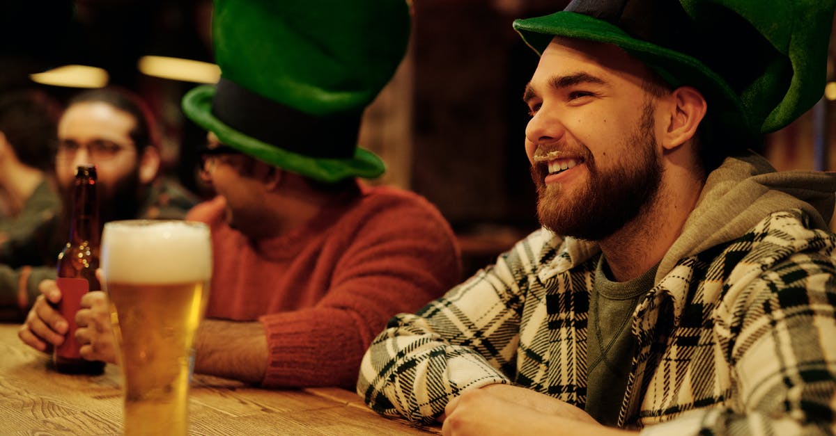 Why is Ken's beer "gay"? - Men Wearing Green Leprechaun Hat Drinking in a Bar