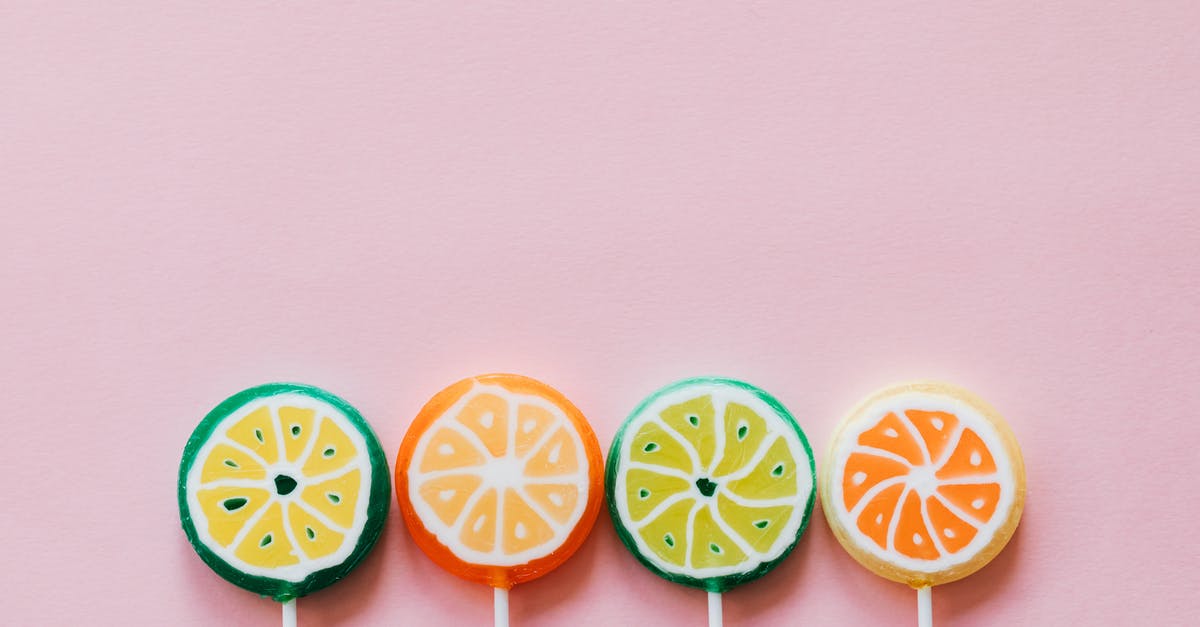 Why is Marcus Corvinus's hybrid nature different from Michael Corvin? - Top view of round multicolored candies with citrus fruit flavor on thin plastic sticks on pale pink surface