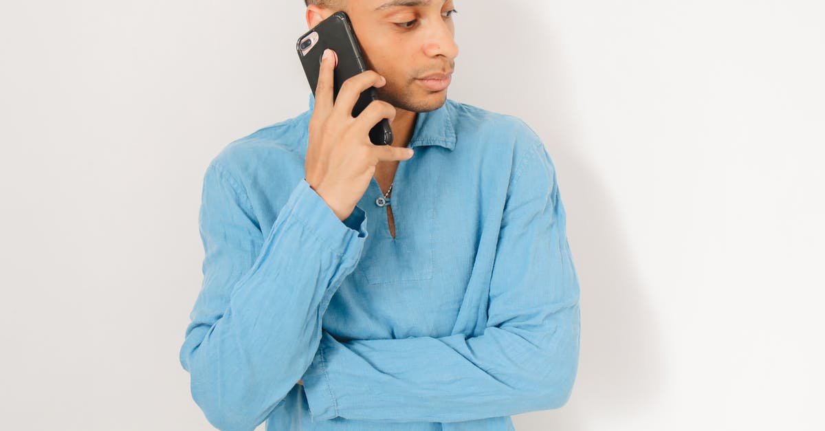 Why is she calling him a loser? - Close-Up Shot of a Man in Blue Long Sleeves Having a Phone Call