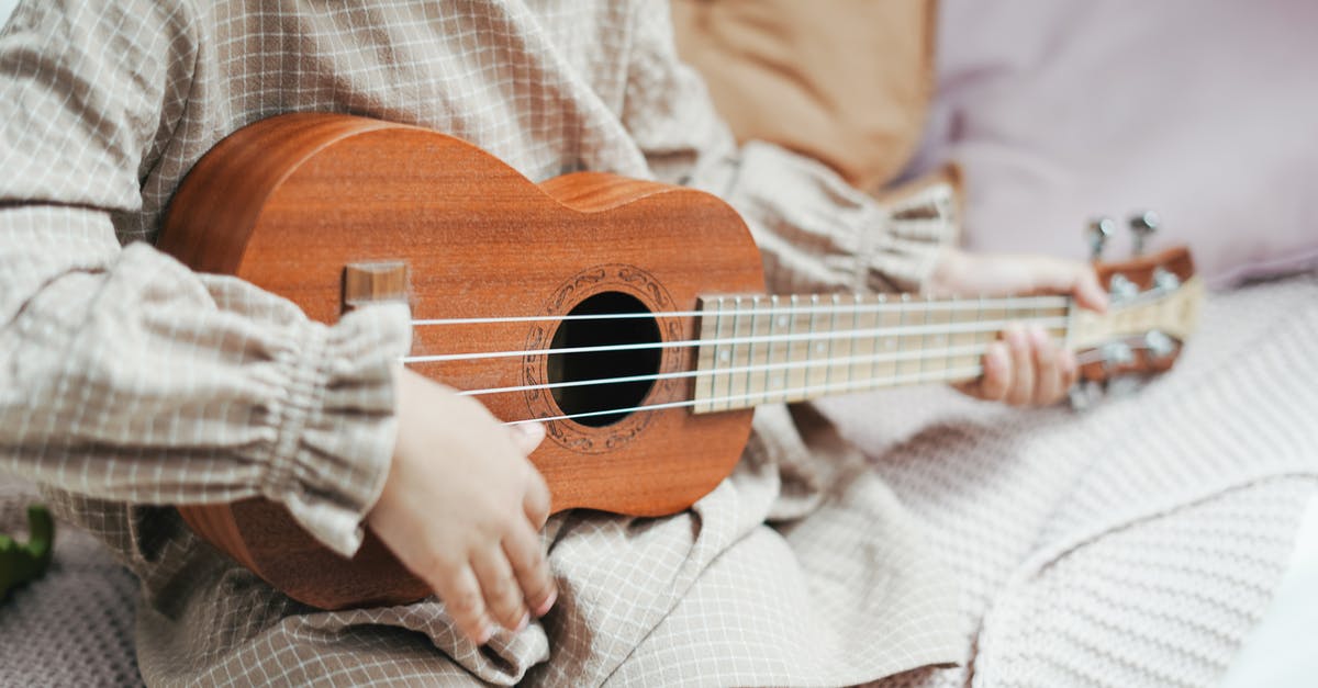 Why is stealing De la Cruz guitar a family matter? - Photo of a Toddler Playing A Ukulele