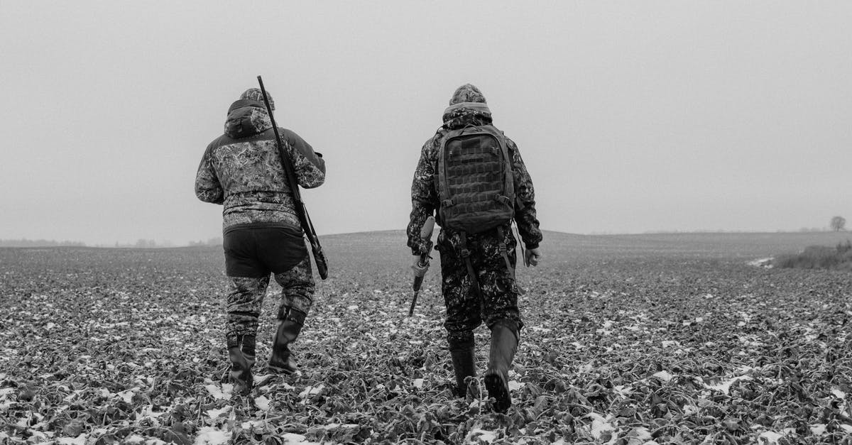 Why is Tell locked back into a military prison? - Grayscale Photo of Two Men Carrying Rifles