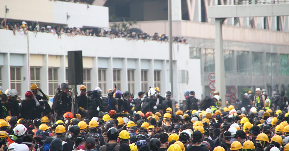 Why is the fighter pilot angry that Akanye saved him from Mechagodzilla? - Crowd of workers on mass meeting for rights