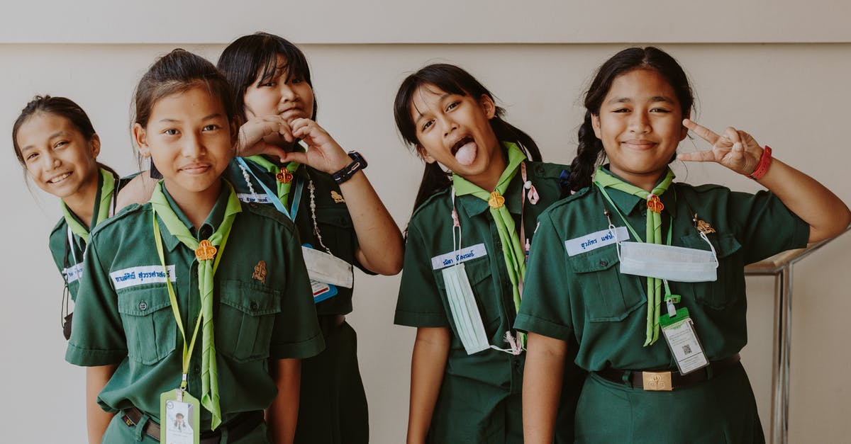 Why is the ghost on the uniform patch making a peace sign? - Young Girls in their Green Girl Scout Uniform