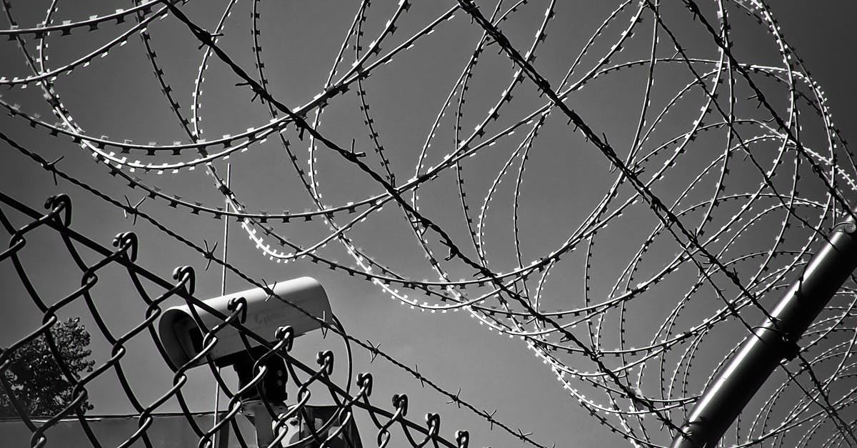 Why is there a safety net conveniently located in the soon-to-be-demolished MI6 building? - Grayscale Photo of Barbed Wire