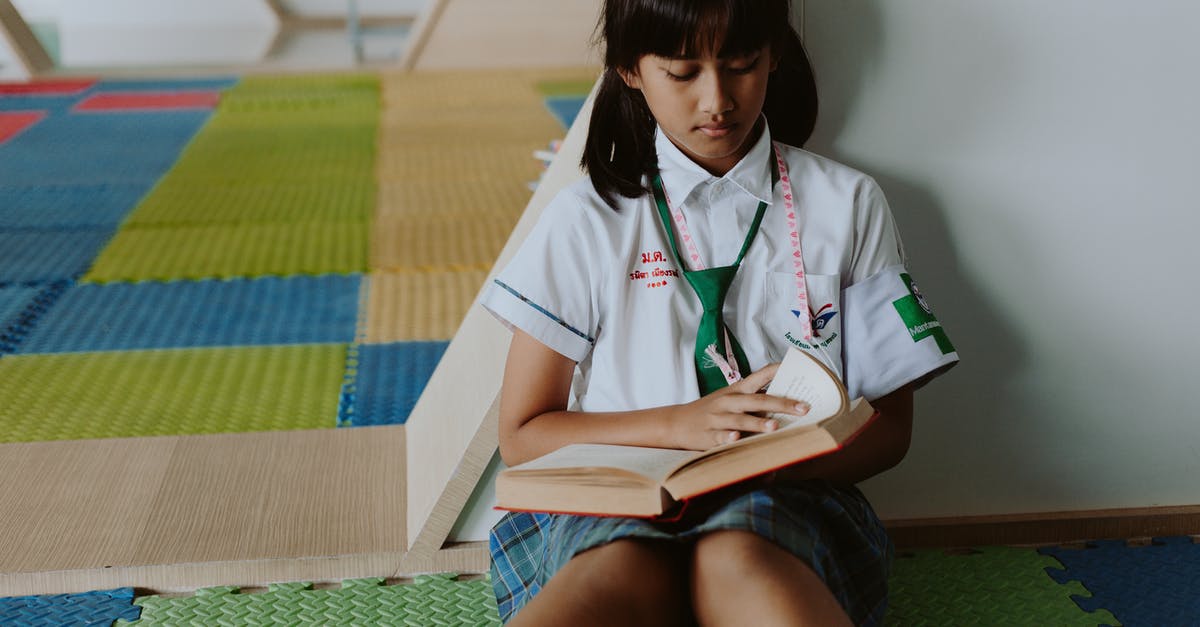 Why is Zev Vendel bother about reading these ground cables? - Thai Girl in School Uniform Sitting on Ground Reading Book