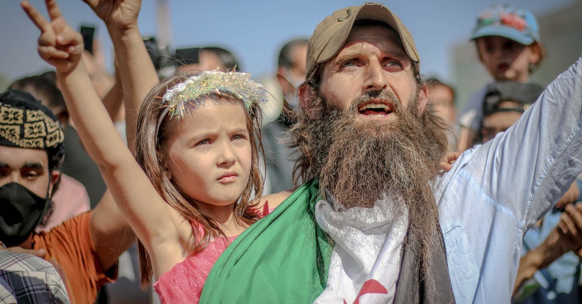 Why not protect against Kilgrave's powers in other ways? - Ethnic bearded man with kid at protest