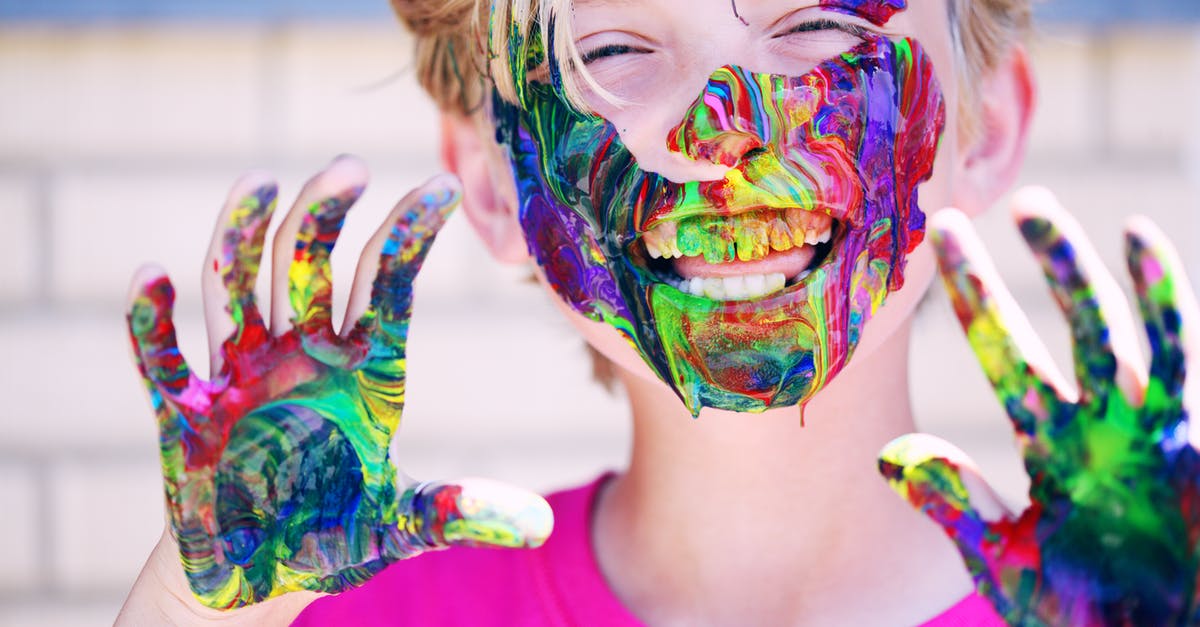 Why painting on the face? - Boy in Pink Crew-neck Top With Paints on His Hands and Face