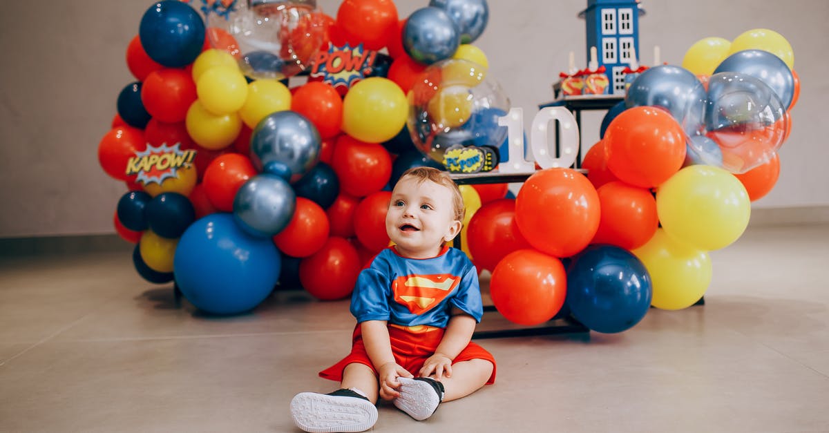 Why Shazam when there is already Superman? - A Boy in a Superman Costume Sitting Near Colorful Balloons