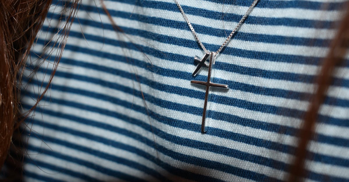 Why the bin bag in Silver Linings Playbook? - Silver-colored Cross Pendant on Black and White Stripe Textile