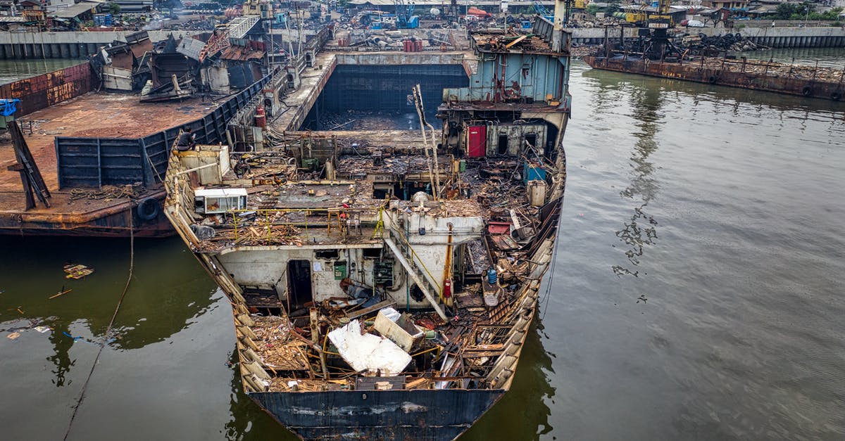 Why the did the Alliance destroy the scuttled settler ship in Episode 3 of Firefly? - From above of aged rusty ship with rubbish moored in abandoned port in cloudy day in daylight