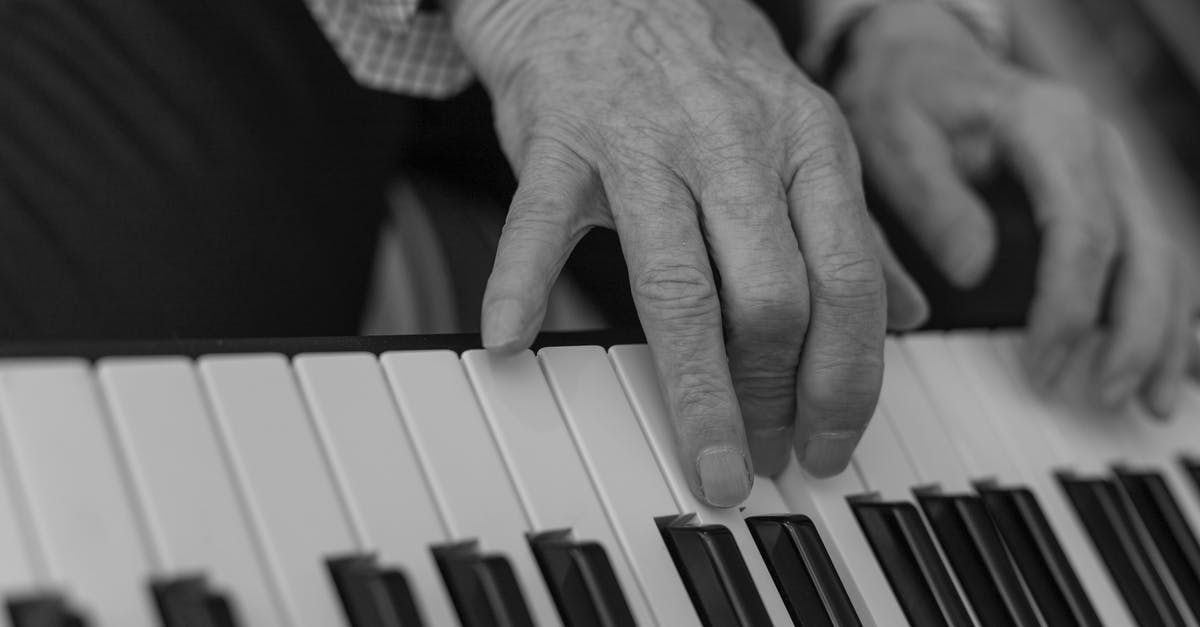 Why the discrepancy between the sound levels of dialogue and music in older movies? - Gray Scale Photo of Person Playing Piano