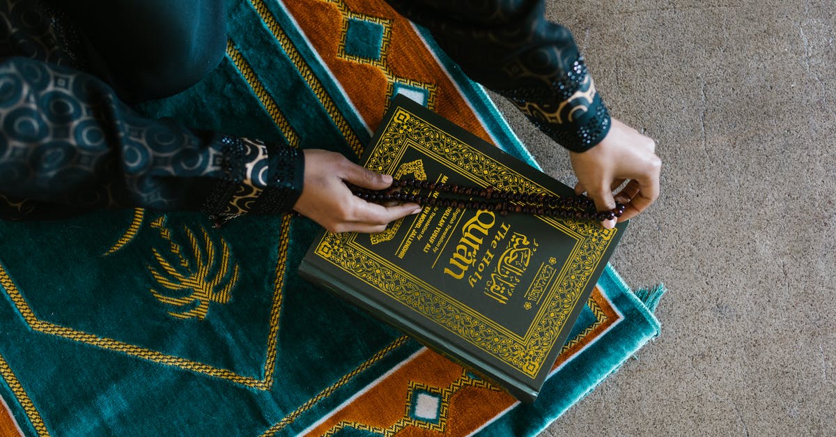 Why the shot of the Muslim Prayer in the opening credits scene? - Hands of a Person Holding a Prayer Beads on a Book