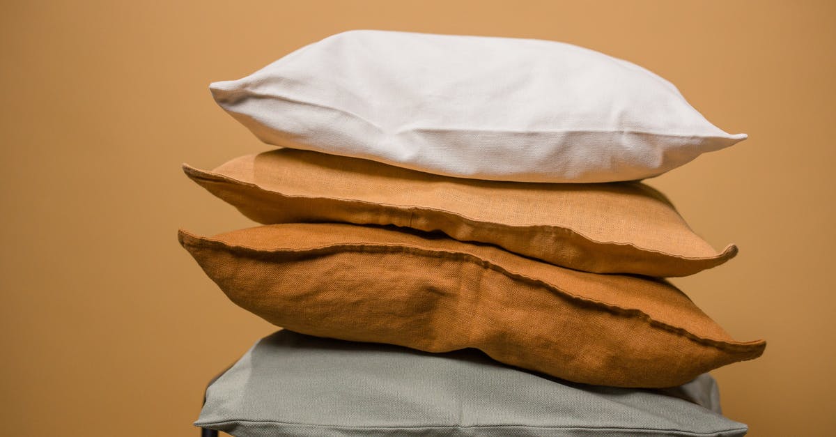 Why the very different release formats for Hitchhiker's Guide to the Galaxy? - Stack of different colorful pillows folded and placed in stack on chair isolated on dark beige background