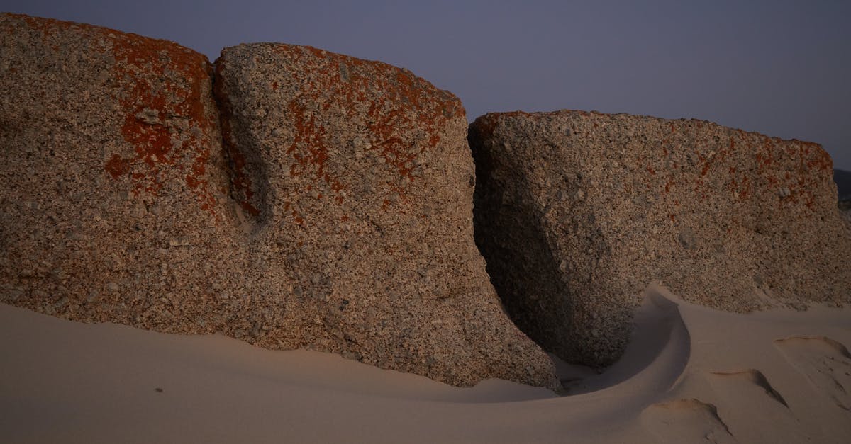 Why this way of making earth uninhabitable in Interstellar? - Stones in sandy terrain in evening
