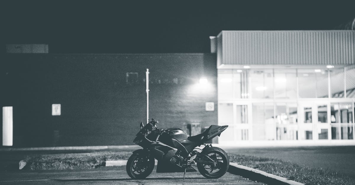 Why was Brandon denied entry to the night club? - Black and white of stylish motorcycle parked on asphalt surface on local street of city at night