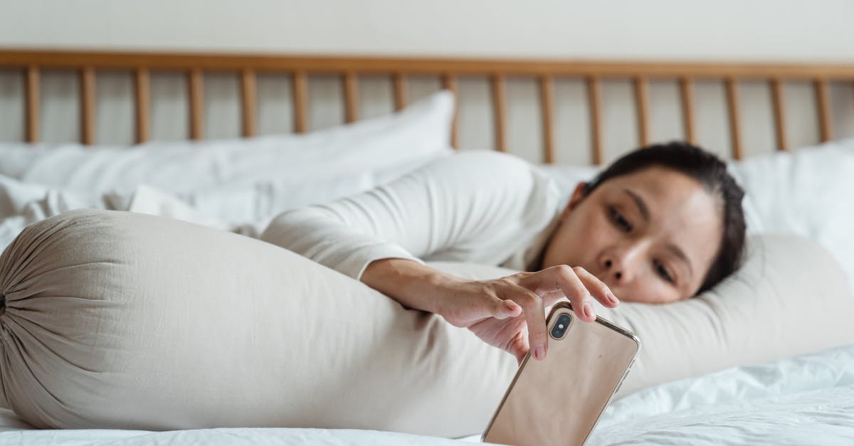 Why was Dragonstone left unoccupied for such a long period of time? - Content young ethnic female watching video on cellphone while lying on comfortable bed with long cylinder pillow in morning and enjoying free time