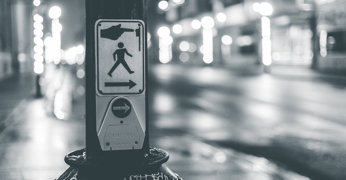 Why was it important to stop the Algorithm from being dropped into the time capsule? - Pedestrian crosswalk button placed near roadway in city in evening time