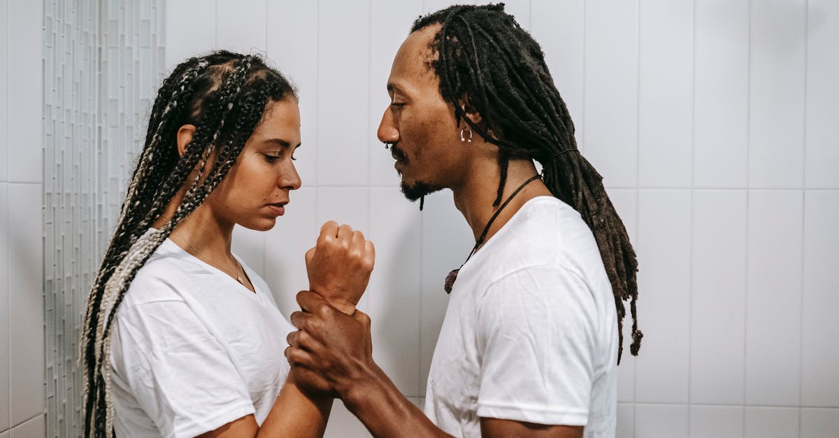 Why was Māui having trouble with his transformation powers? - Side view of young muscular African American male holding arm of female partner while struggling in house