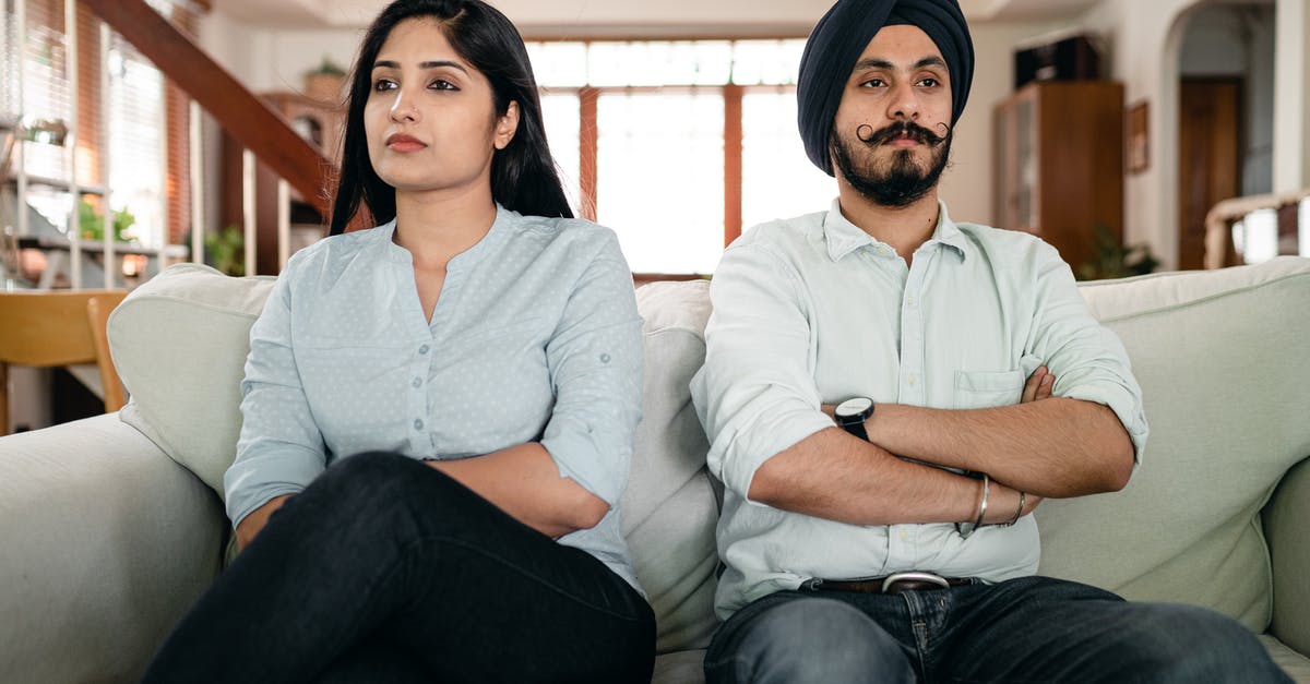 Why was queen Victoria upset when she found out that Abdul was married? - Resentful young Indian couple ignoring each other while sitting on couch together with crossed arms