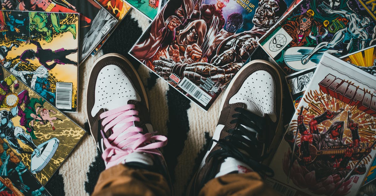 Why was Romeo + Juliet set in modern times? - From above crop person wearing brown trousers and sneakers standing on pile of collection of comics magazines with colorful illustrations on cover