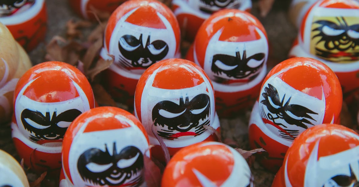 Why was the doll from Annabelle so treasured? - From above set of red traditional Japanese daruma dolls with black painted faces symbolizing good luck placed together on street