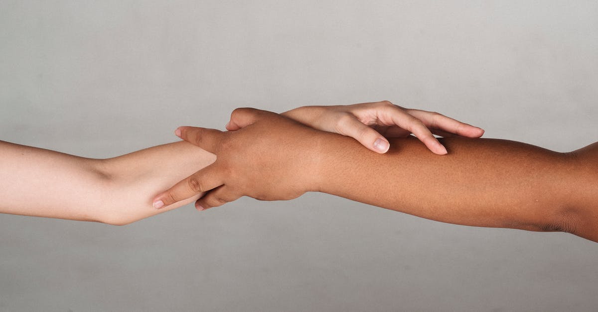 Why was the landing of Friendship 7 skipped in The Right Stuff? - Crop anonymous multiracial female demonstrating unity and tolerance while reaching hands to each other in studio against gray background