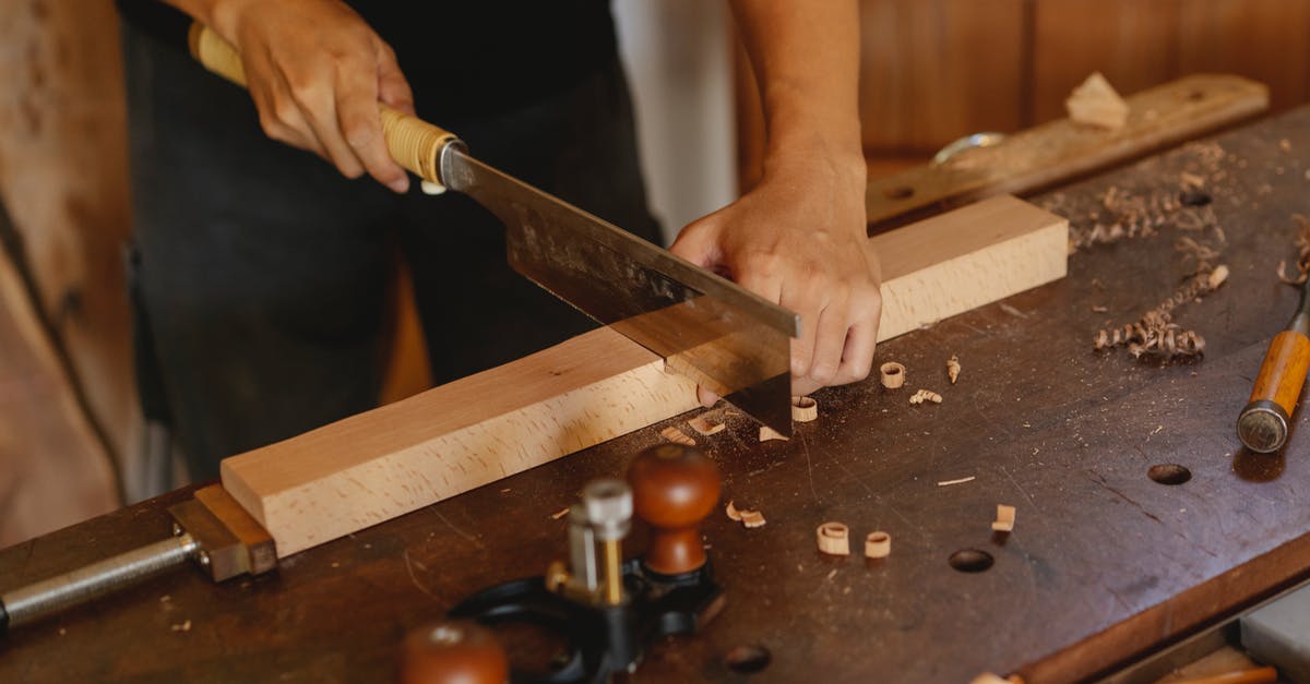 Why was the saw scene cut from Ferdinand the Bull? - Craftsman cutting wooden detail with saw