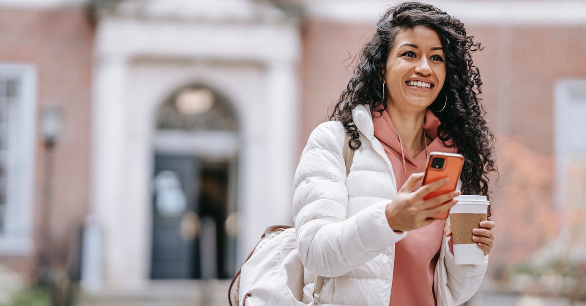 Why was Vanessa apparently allowed to go free? - Cheerful young ethnic female student with long curly hair in casual clothes and backpack smiling and looking away while using mobile phone standing in campus with takeaway coffee