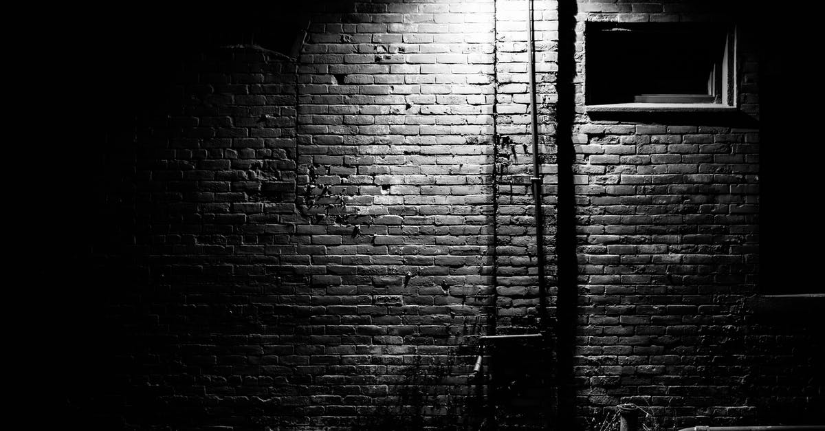 Why was Walter sprinting late at night in Get Out - Black and white of aged building with brick walls in bright light of streetlamp