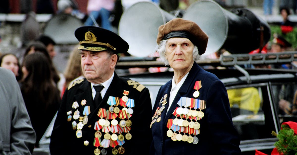 Why were Erik's medals blurred? - Shallow Focus Photo of Two Persons Wearing Military Uniform