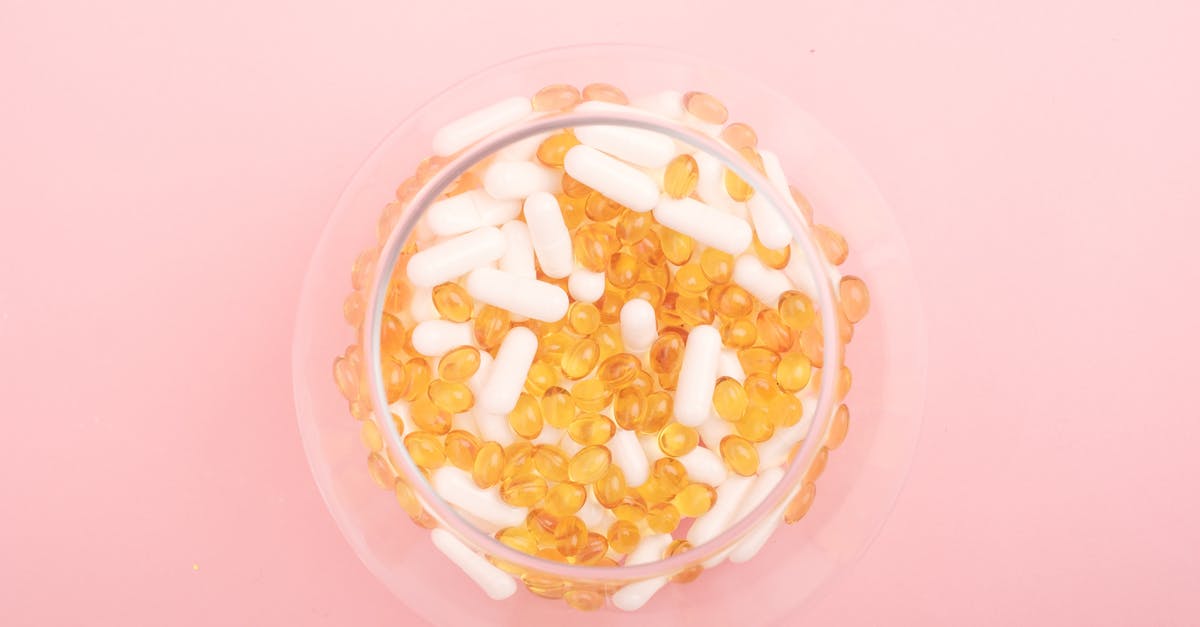 Why were so many questions required in the Voight-Kampff test? - Top view of glass bowl filled with many capsules and pills for curing disease on pink background