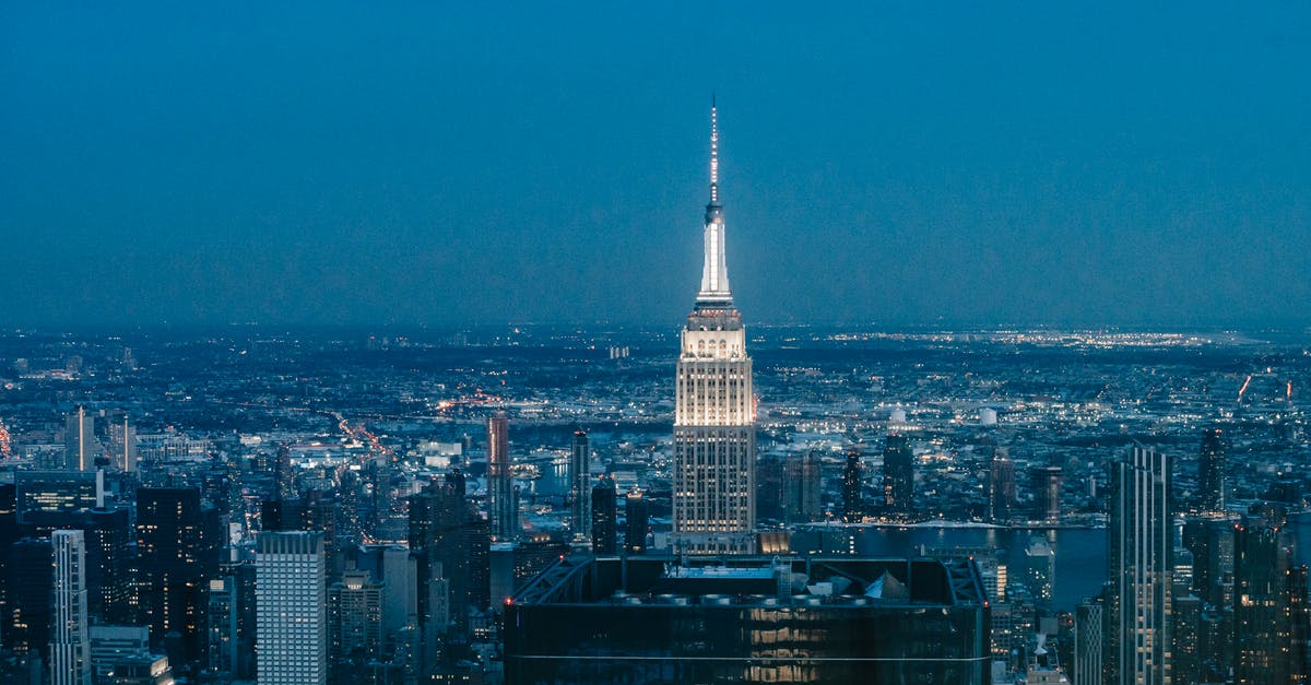 Why would a British counsellor with a PhD work at a public California high school? - High tower with glowing lights located in downtown of New York city among glass buildings at night