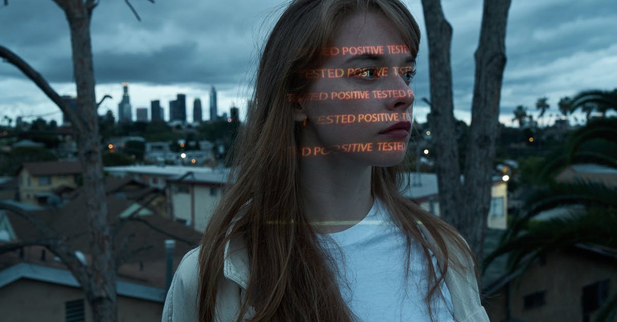 Why would Vivian think that Edward couldn't afford $300 for her to stay the night? - Emotionless young female in casual outfit with illuminating letters on face standing on rooftop against blurred city view at dusk and looking away thoughtfully coronavirus concept