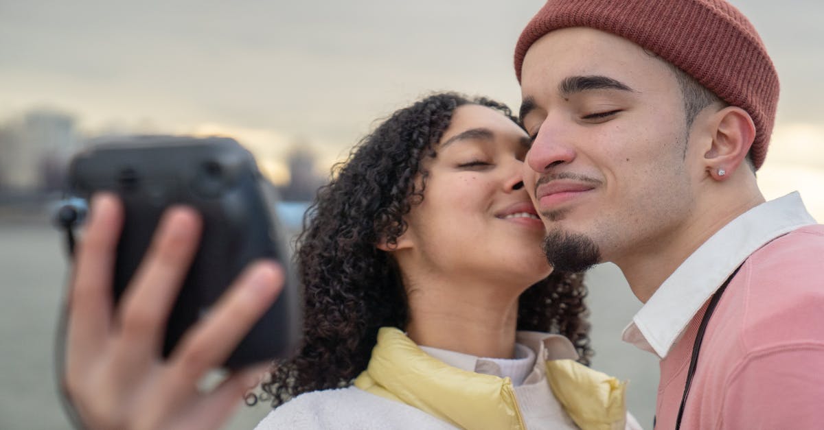 Woman loses her memory in the end [closed] - Happy Hispanic couple taking selfie near sea
