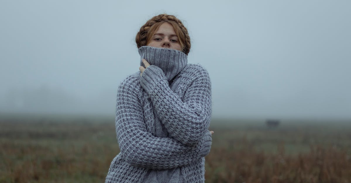 Woman mistakenly orders a hit on herself [closed] - Young Redhead Woman in Gray Knitted Pullover Standing in Fields