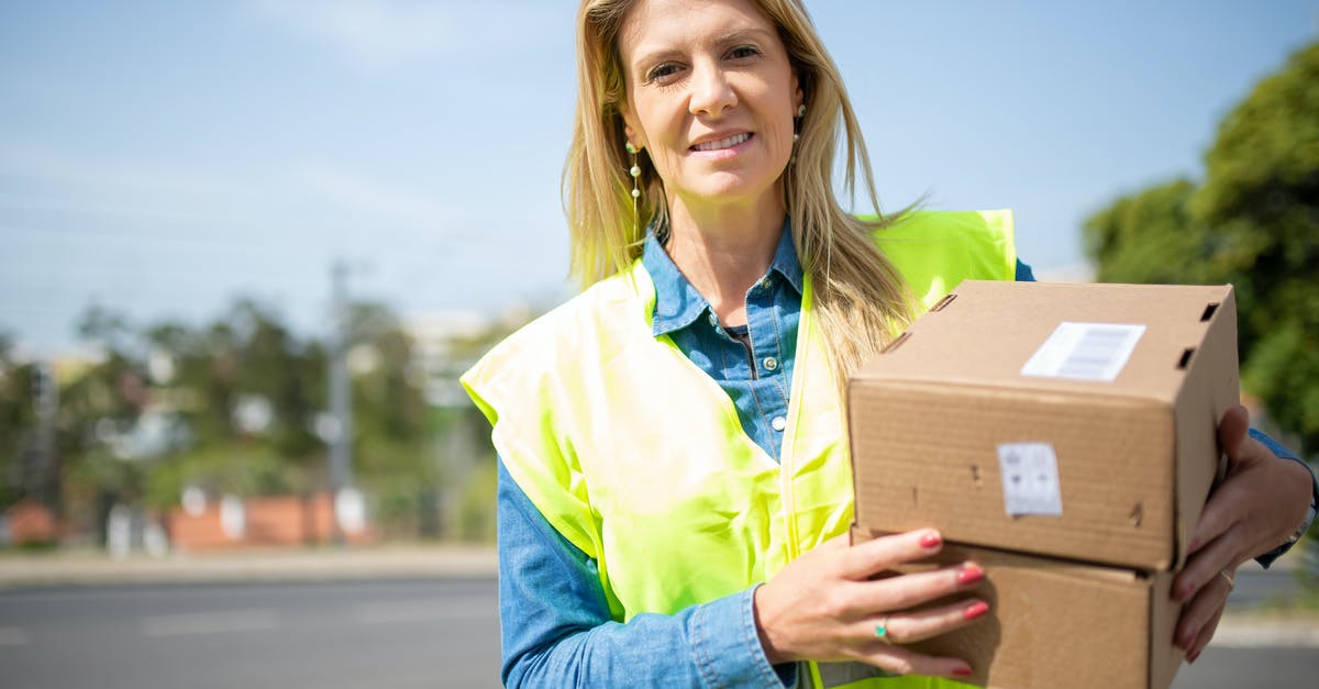 Woman mistakenly orders a hit on herself [closed] - Close-Up Shot of a Deliverywoman Holding Delivery Boxes
